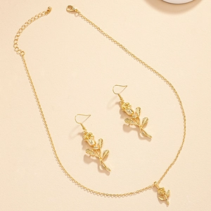 Golden rose jewelry set with delicate flower necklace and matching hook earrings