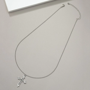 Detailed view of silver gothic cross pendant with lobster clasp and adjustable chain