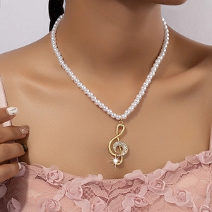 Elegant pearl necklace with golden treble clef pendant and rhinestones for women