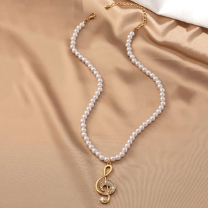 Elegant gold musical note pendant necklace with white pearls and sparkling rhinestones