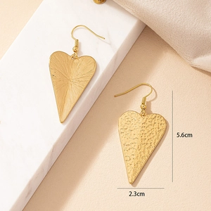 Detailed size view of gold heart dangle earrings with textured finish, 5.6cm by 2.3cm