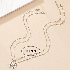 Detail of silver Best Friend heart necklaces with Friends Forever engraved pendants