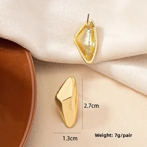 Detailed macro shot of matte gold geometric rhombus earrings with size specifications