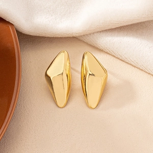 Irregular geometric gold studs with a sleek metallic mirror finish and minimalist design