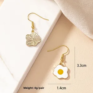 Detailed size and weight view of handmade fried egg earrings with flower charms