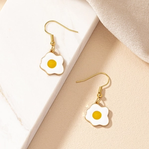 Charming fried egg drop earrings with golden hooks on minimalist marble background