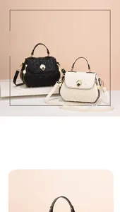 Close-up of quilted shell handbags with golden clover clasps in black and white colors