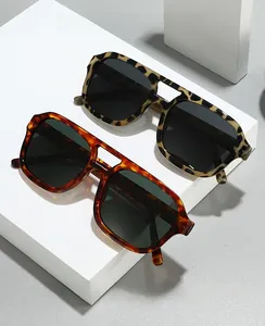 Close-up of retro double-bridge pilot sunglasses in leopard and amber patterns