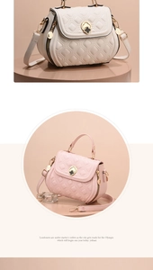 Detail of quilted shell bag featuring golden clover lock and adjustable strap