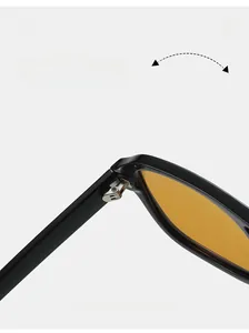 Detail of durable metal hinge on black pilot sunglasses with orange lenses