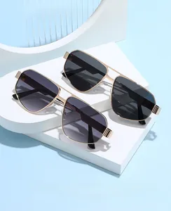 Detail of pilot sunglasses with gold metal frame and embossed textured hinge hinges