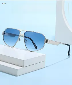 Detail of silver metal double bridge sunglasses with blue gradient lenses and textured temples