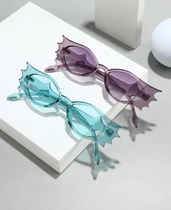 Detail of purple and blue bat-wing sunglasses on white blocks with soft shadows