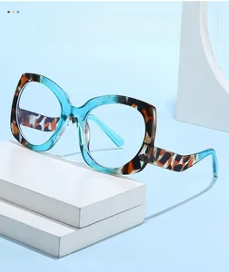 Detail of blue acetate frame sunglasses with lightning-shaped temples on white stone