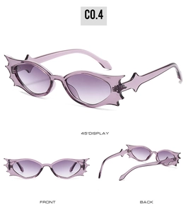 Macro view of purple bat-wing shaped sunglasses frame with Y2K gothic punk aesthetic