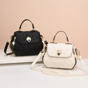 Quilted shell-shaped tote bags in black and beige with gold clover metal hardware
