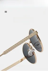 Detail of metal temple with geometric texture and silicone pads on oval sunglasses