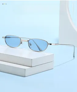 Close-up of silver metal frame sunglasses with light blue lenses on geometric blocks