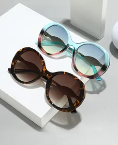 Detail showing oversized retro frames in tortoiseshell and blue gradient finish