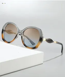 Detail of gradient resin lenses and sleek metallic temple design on modern oversized eyewear