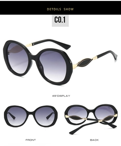 Detail view of oversized retro frames with gradient purple lenses and gold leaf temples