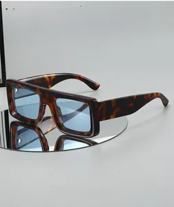 Detail shot of wide tortoiseshell sunglasses frames with blue lenses on a mirror