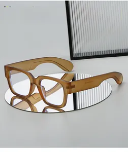 Detail of amber tortoiseshell glasses with anti-blue light lenses on a reflective mirror