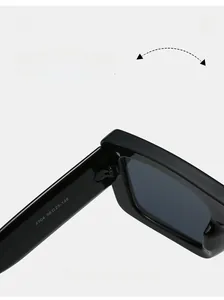 Detail of durable texture hinge and white size specs on black oversized sunglasses