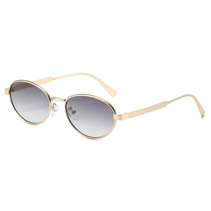 Retro oval sunglasses with gold metal frame and grey gradient lenses in side view