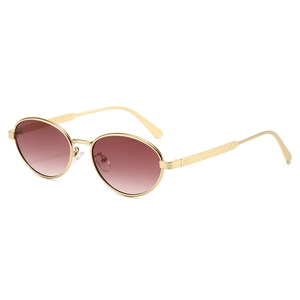 Vintage oval sunglasses with gold metal frame and reddish-brown gradient lenses on white backdrop