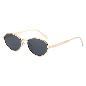 Retro oval sunglasses with gold metal frame and embossed textured temples on white background