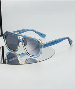 Detail of blue translucent aviator frames with gold metal core and gradient lenses