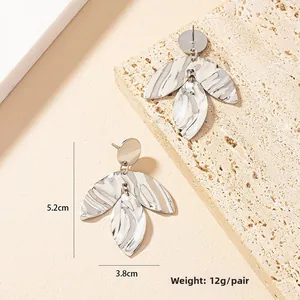 Detailed view of silver leaf earrings with irregular texture measuring 5.2cm by 3.8cm