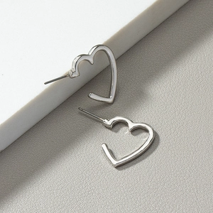 Minimalist silver hollow heart earrings with polished finish on a clean background