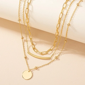 Three-layer gold necklace set featuring paperclip chain, metal beads and round pendant