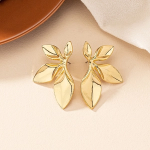 Exaggerated golden petal earrings in minimalist floral design with glossy metal finish