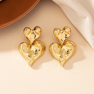Irregular gold heart earrings with lava texture design in minimalist vintage style