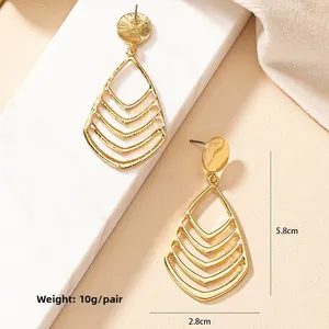 Detail view of hollow teardrop earrings with V-shape layers measuring 5.8cm by 2.8cm