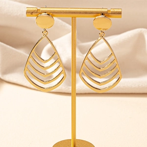 Elegant gold-tone multi-layer hollow teardrop earrings on a metal display stand