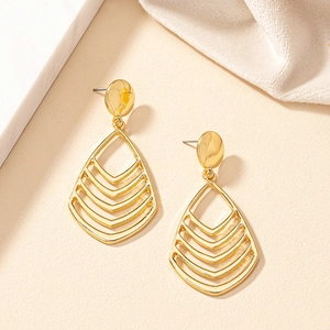 Macro view of water-drop hollow geometric earrings in 18K polished gold finish