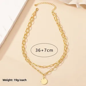 Detail of gold layered paperclip chain necklace with round pendant showing 36+7cm length