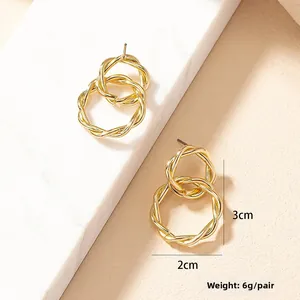 Detailed size view of twisted gold hoop earrings measuring 2cm by 3cm with 6g weight