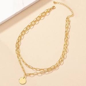 Double-layered gold paperclip chain necklace with a minimalist round coin pendant