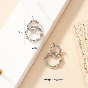 Detailed view of silver double-loop knot earrings with dimensions 3cm height and 2cm width