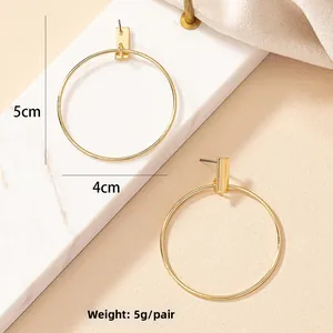 Detail view of gold oversized hoop earrings showing 4cm and 5cm size measurements