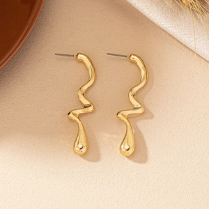 Detailed shot of gold liquid metal wave earrings with high-polished mirror finish