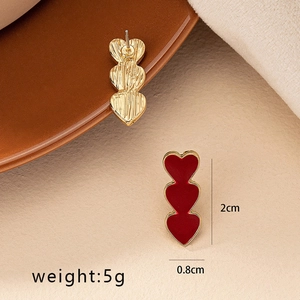 Detail showing red triple-heart drop earrings with size 2cm by 0.8cm and 5g weight info