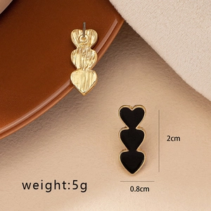 Elegant gold-tone triple heart drop earrings with black enamel inlay and 2cm length