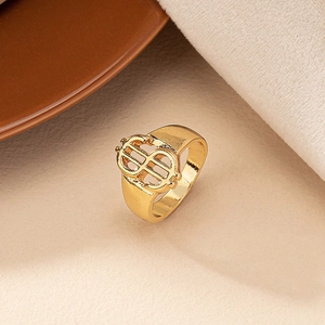 Detailed view of hollow gold dollar sign ring with polished finish in hip hop style