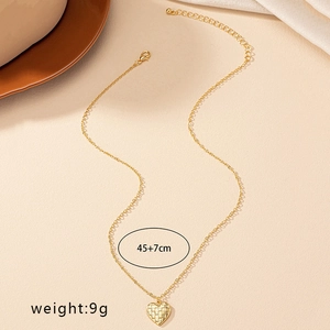 Vintage gold heart pendant necklace with checkered pattern and adjustable chain